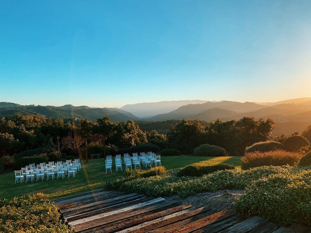 Luxury outdoor wedding ceremony with floral decor at sunset